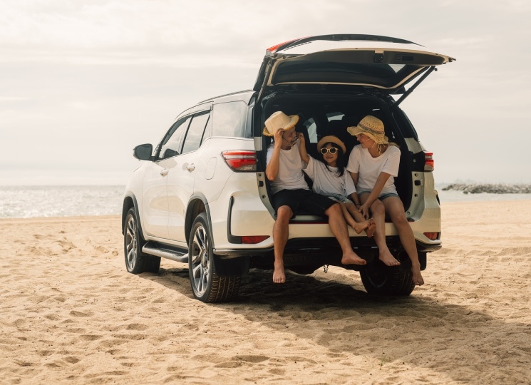 Family in car on a beach